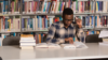 Black man studying in library