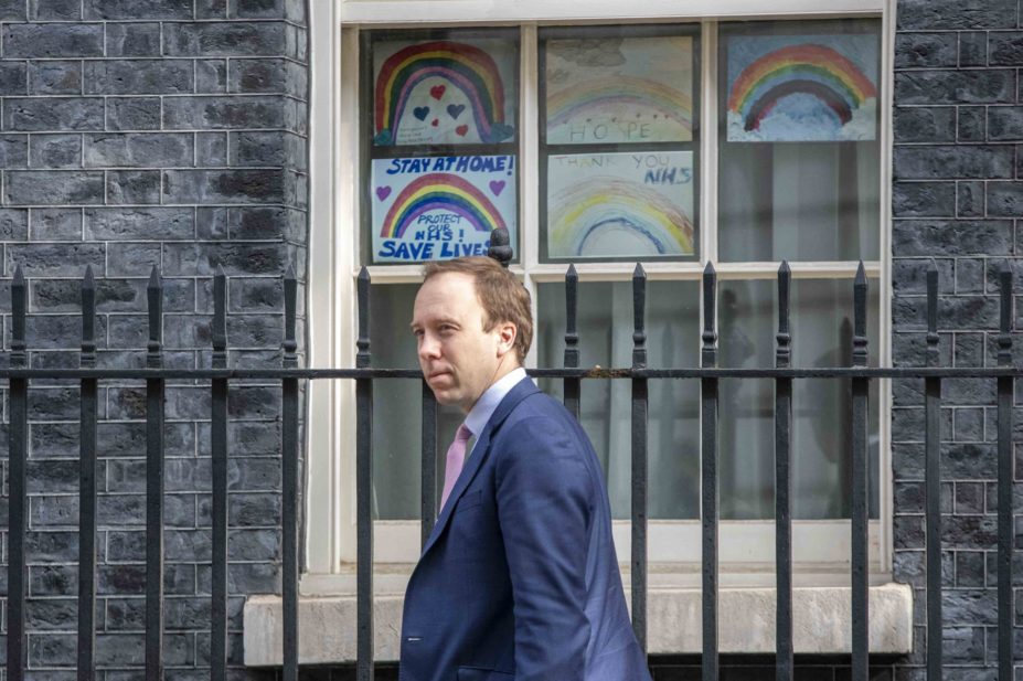Matt Hancock in front of Save the NHS signs in Downing Street