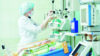 doctor treating baby in neonatal intensive care unit