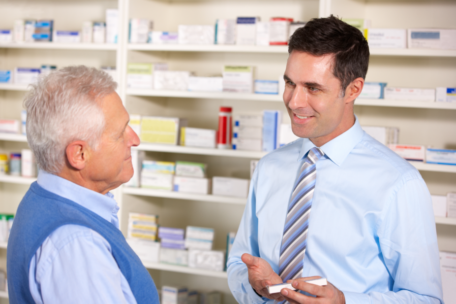 Pharmacist explains medicine to old man
