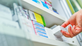 Pharmacist selecting medicine box