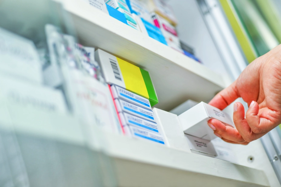 Pharmacist selecting medicine box