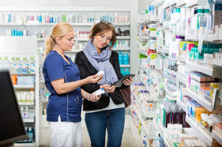 Pharmacy staff helping a patient