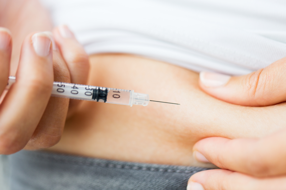 Woman with diabetes injecting insulin