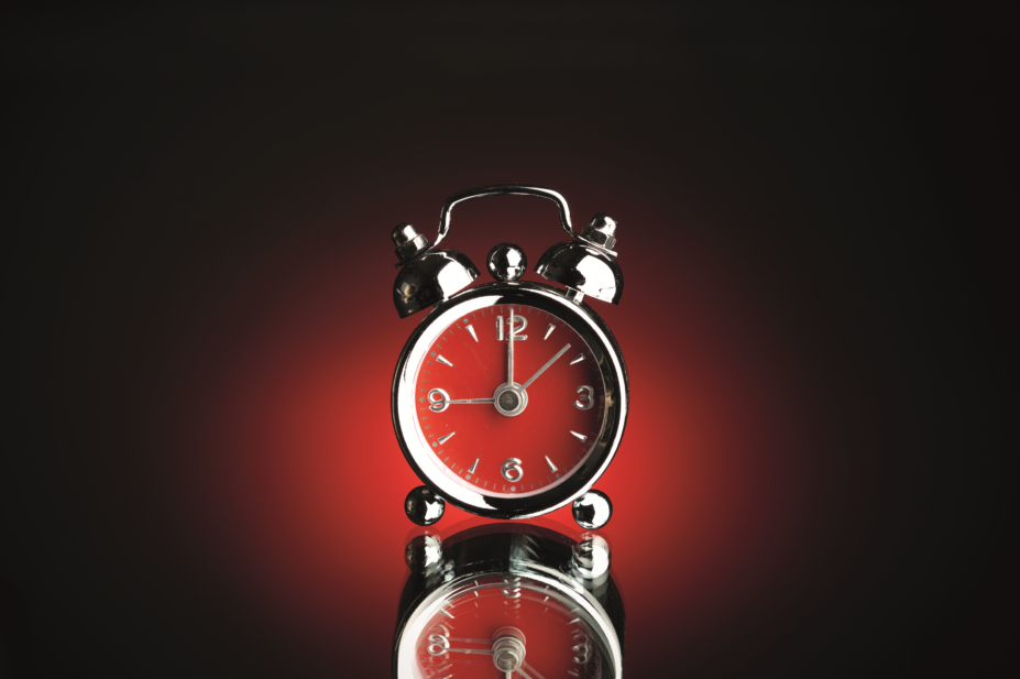 Alarm clock against a red background