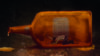 Illustration of a man trapped in a liquor bottle representing alcohol addiction