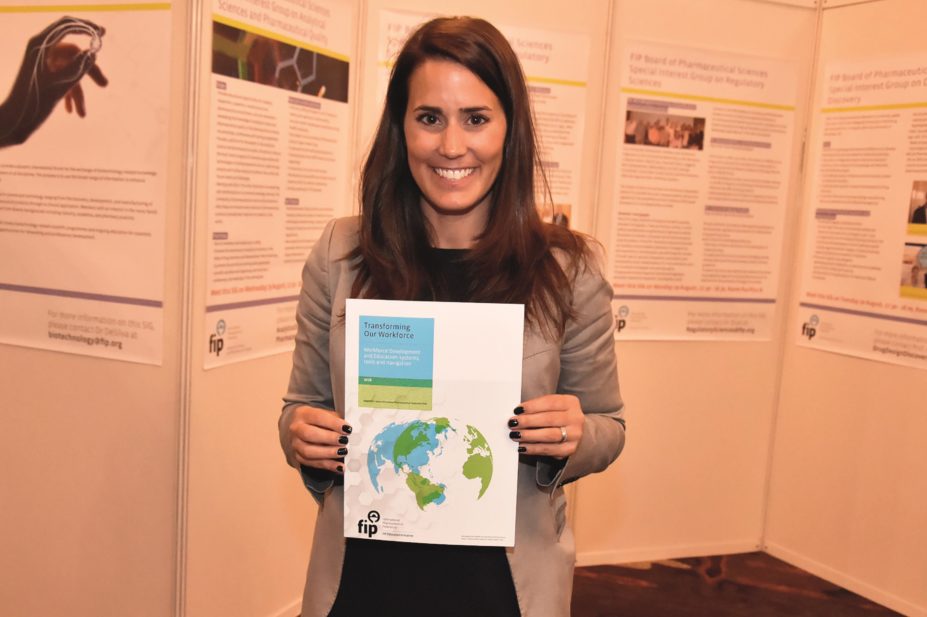 Andreia Bruno, FIPEd project coordinator and researcher, holds up a copy of 'Transforming Our Workforce' 2016 report