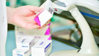 Pharmacist scanning barcode as part of falsified medicines directive process
