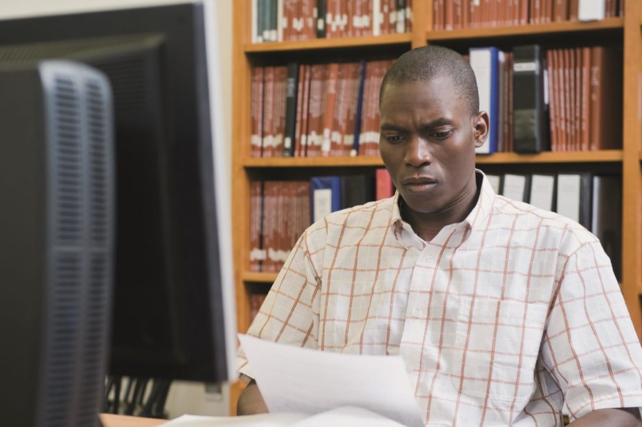 Black African university student studies in library