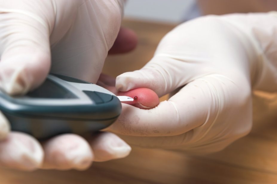 A blood glucose test being carried out