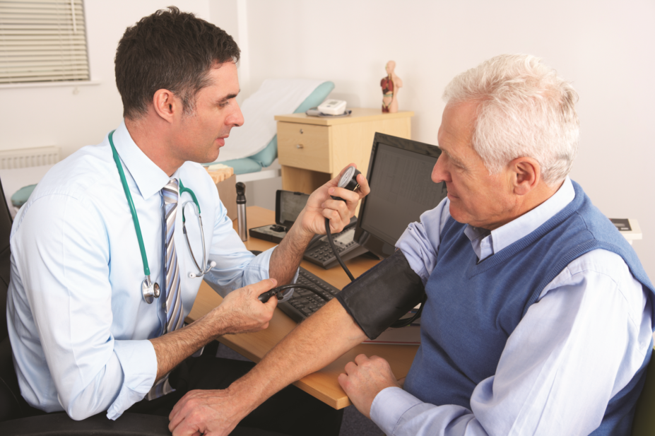 GP takes blood pressure of patient