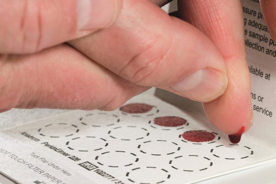 Close-up of a person taking a dry-blood spot test