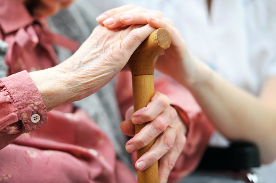Care giver holding hands with an older patient