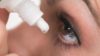 Close up of a person putting eye drops