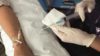 Close up of a nurse injecting a chemotherapy drug intravenously through a patient's arm