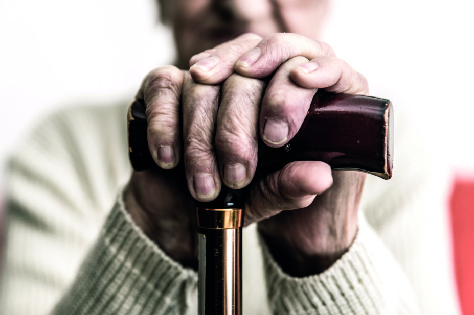 Close up of elderly man holding cane