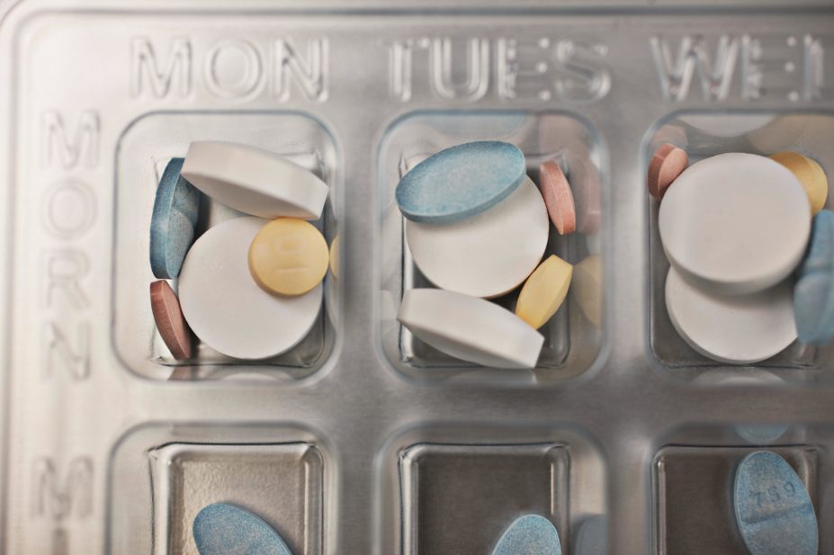 Close-up of a pill box showing different number of medicines