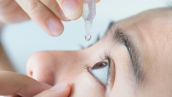 closeup woman applying eye drops artifical tears ss 17