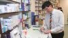 One in five prescription interventions made by community pharmacists relate to medicines shortages, suggest the findings of an audit. In the image, a pharmacist in a dispensary looks at a few medicine boxes