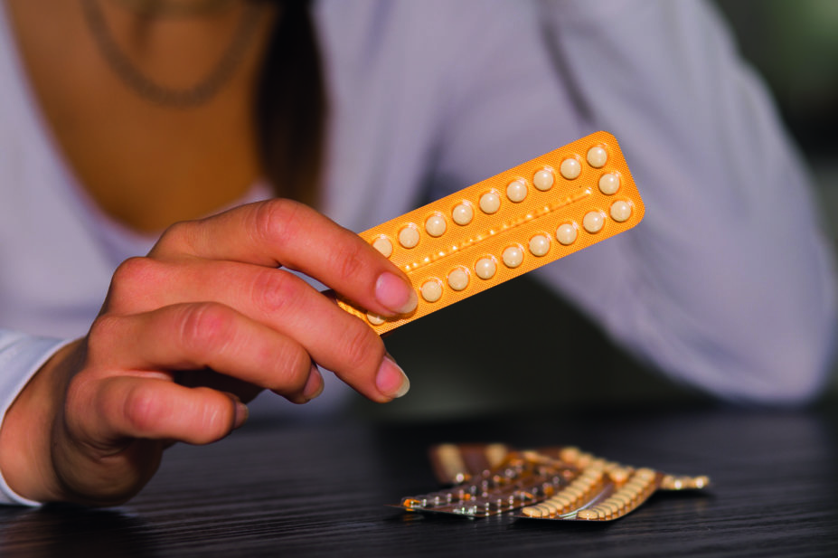 Woman holding a blister pack of the contraceptive pill