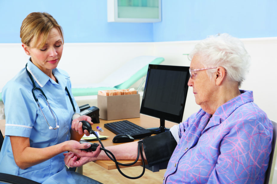 nurse checking blood pressure as part of diabetes checkup