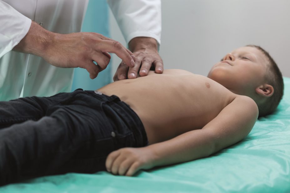 Surgery may not be necessary for children with uncomplicated appendicitis. In the picture, a doctor examining a boy's abdomen.