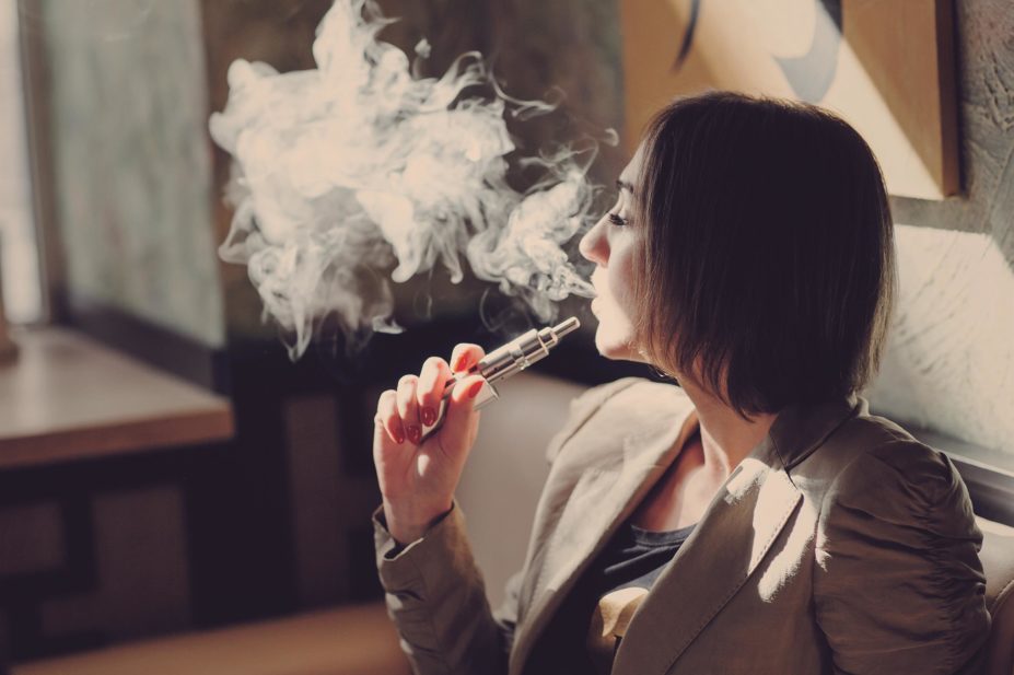 The Scottish government intends to regulate the sale of e-cigarettes and restrict their advertising as part of proposals outlined in the Health (Tobacco, Nicotine etc and Care) (Scotland) Bill. In the image, a woman smokes an e-cigarette