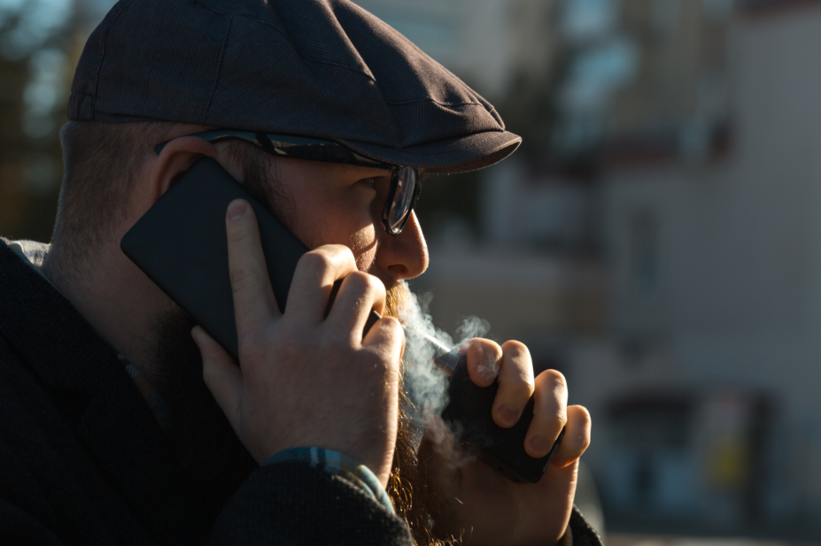 Man smoking e-cigarette outside