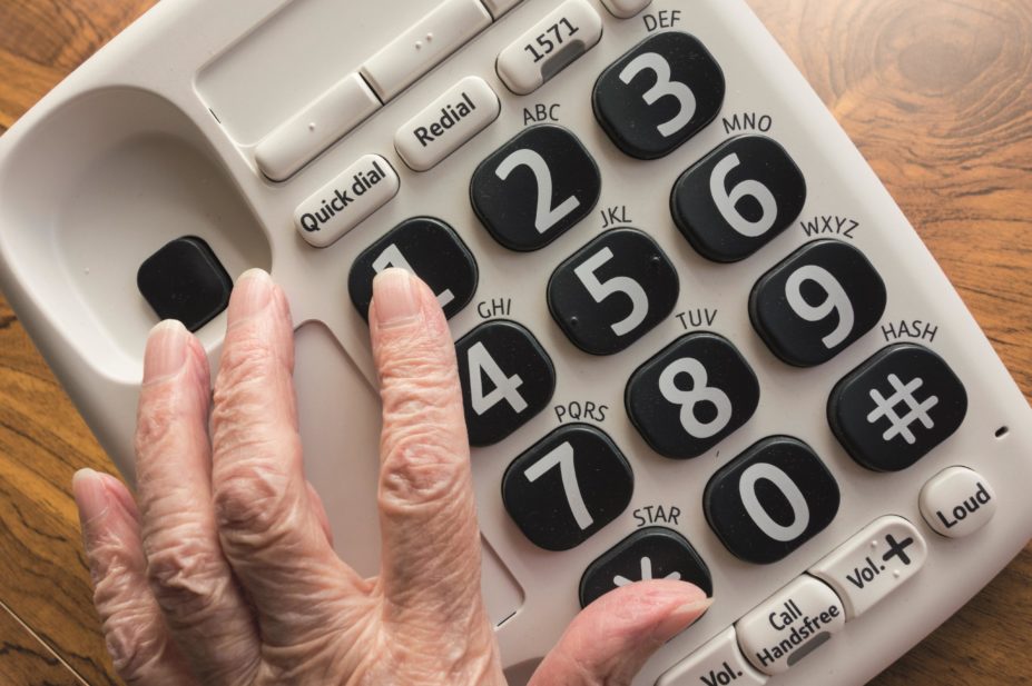 Less than 1% of NHS 111 callers are directed to a pharmacy. In the image, an elderly woman dials NHS 111