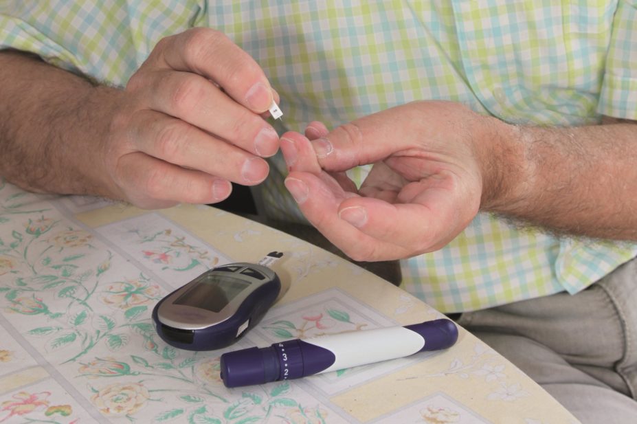 Elderly man taking a glucose test