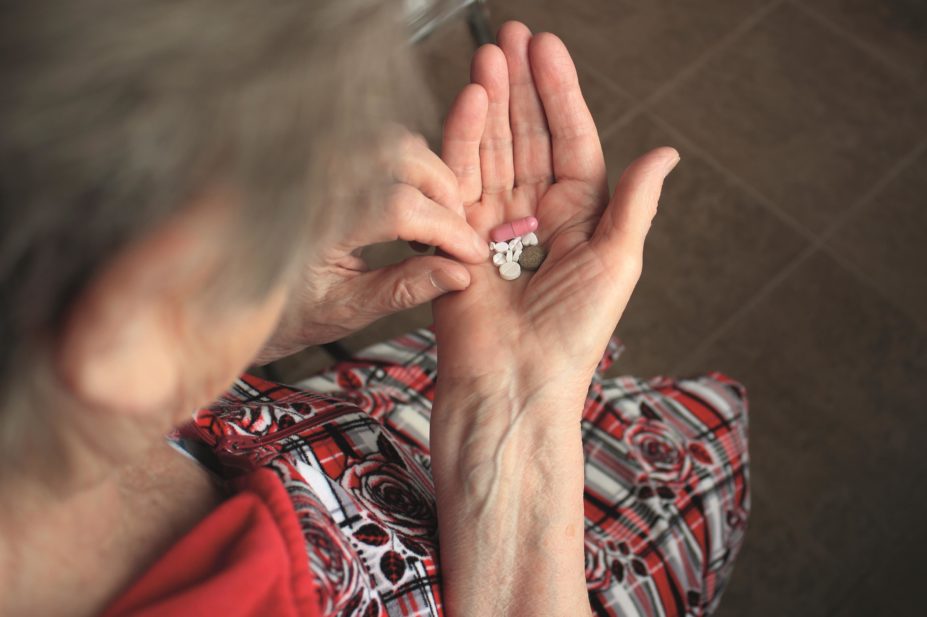 Healthcare professionals can reduce inappropriate prescribing of drugs in older people who are taking four or more medicines which has the potential for negative outcomes. In the image, a woman holds multiple medicines in her hand