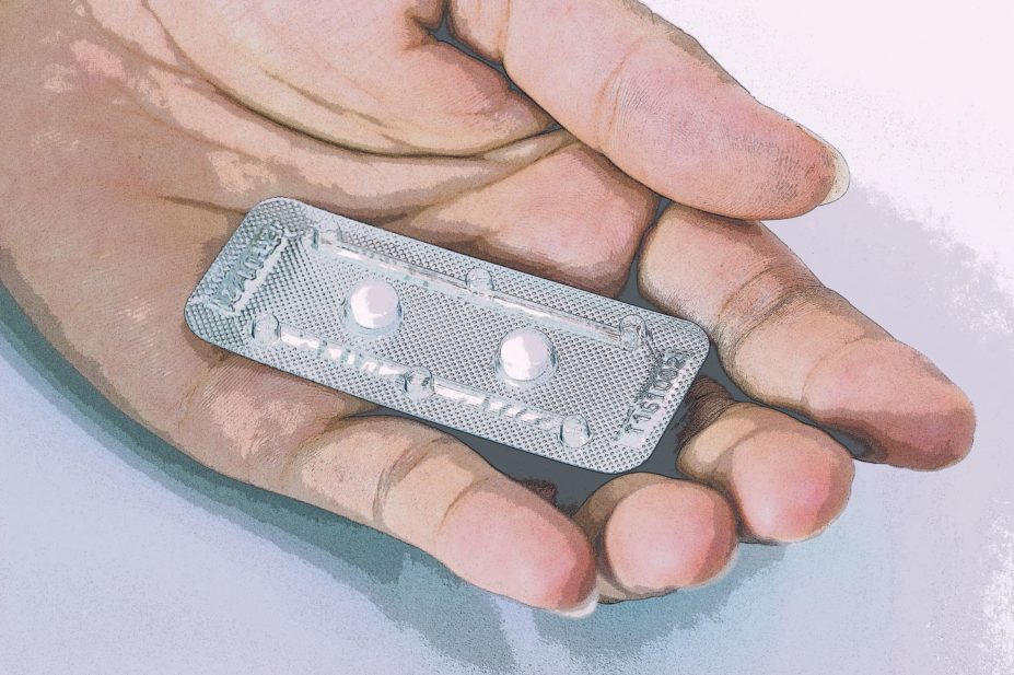 Open hand holding emergency hormonal contraception (EHC)