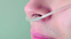 Close up of woman using oxygen tubes in nose
