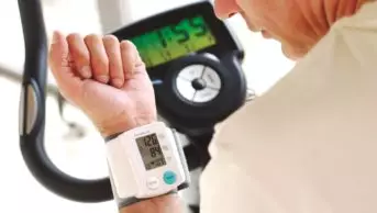 Someone measuring their blood pressure while exercising