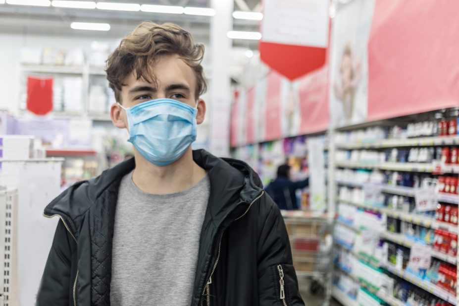 Man wearing face mask in pharmacy