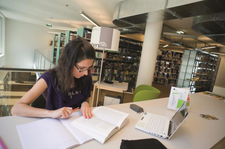 Female student researching in a library
