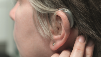 Close up of older woman with hearing aid