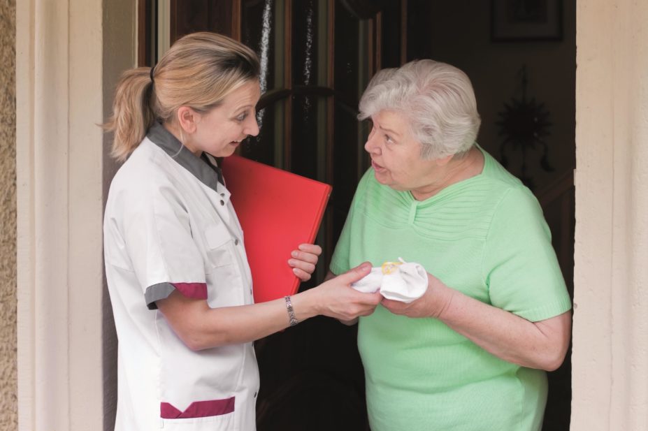 Caregiver visits elderly patient at home