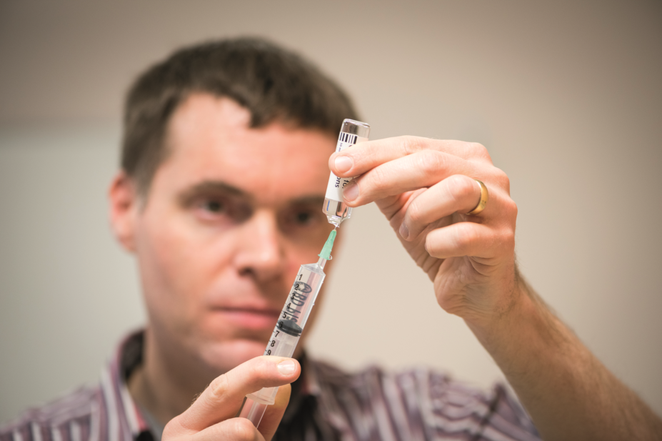Matthew Jones, lecturer in pharmacy practice at the University of Bath readies an injection