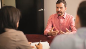 A candidate during an interview talks with the interviewees