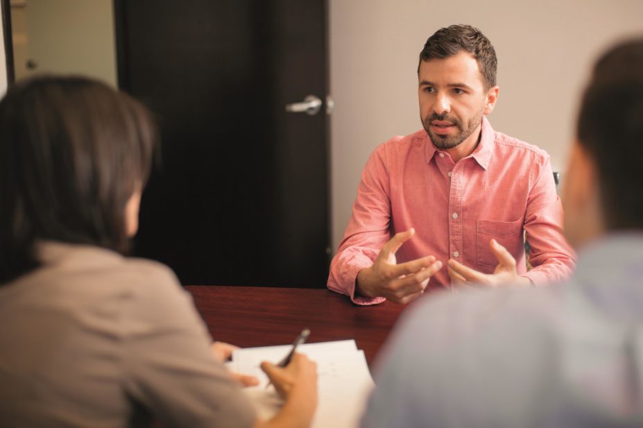 A candidate during an interview talks with the interviewees