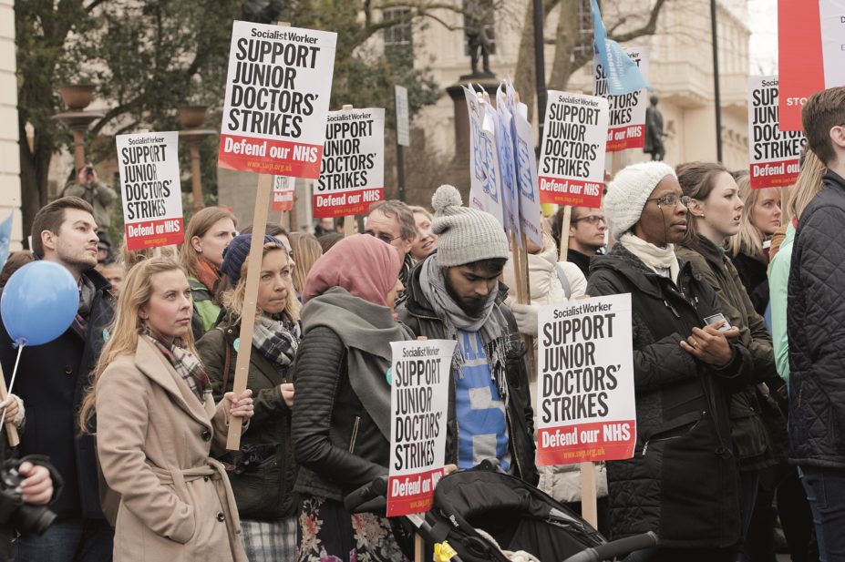 Supporters in central London carry placards in protest of government plans to change NHS junior doctor contracts