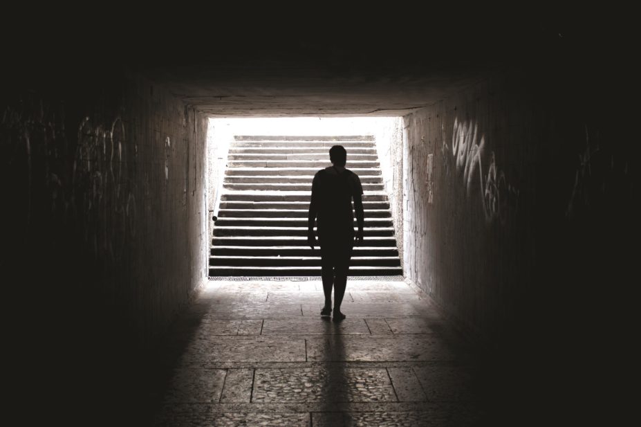 Making a mistake at work can leave anyone lacking confidence and unsure how to proceed. This article discusses how pharmacists should deal with errors and overcome the aftermath. In the image, a person walks towards the light at the end of a tunnel