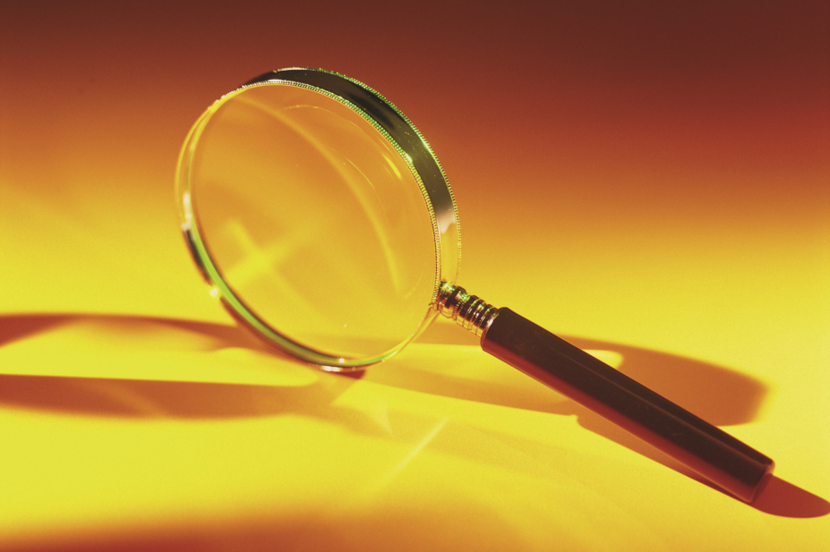 Magnifying glass against a yellow background