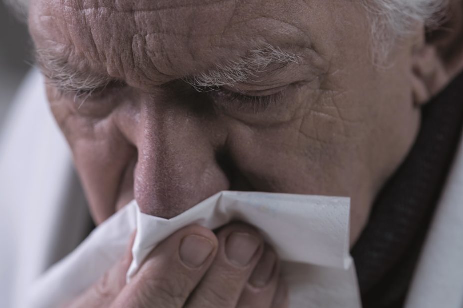Taking paracetamol to manage influenza makes no difference in terms of fighting the virus or reducing patients’ temperature or other symptoms, according to research. In the image, close-up of a man with the flu blow his nose