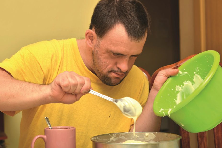 Further evidence has emerged that confirms high levels of inappropriate prescribing of antipsychotics to adults with learning disabilities. In the image, a man with down syndrome making a cake