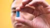 Man holding Truvada PrEP pill