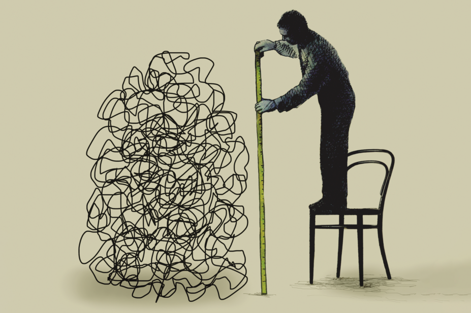 Man on chair measures tangled mess