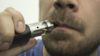Close up of a man smoking an e-cigarette