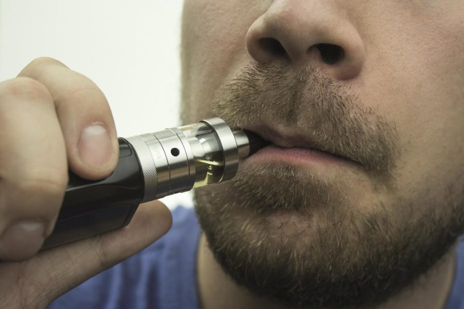 Close up of a man smoking an e-cigarette